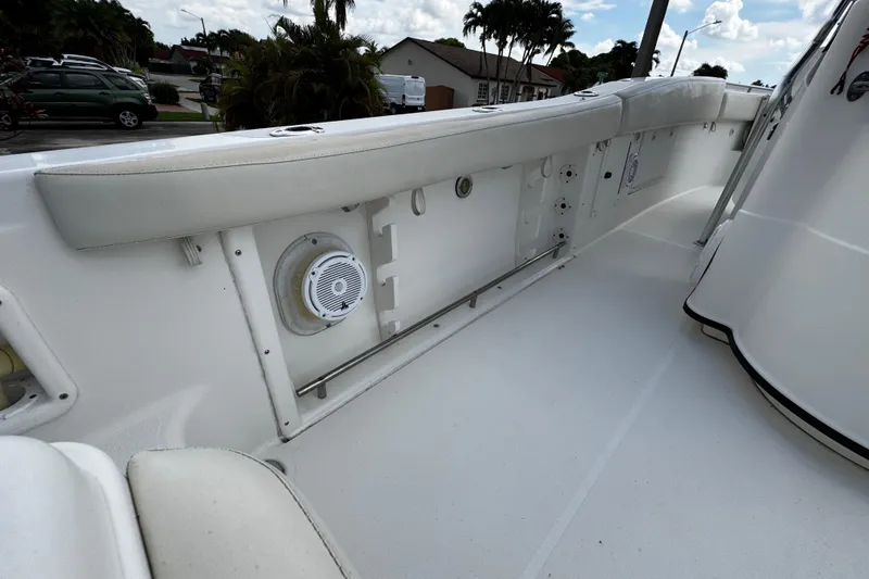 Slide: The Image of 2003 Triton 2895 CC boat interior with white seating and speaker. - 20