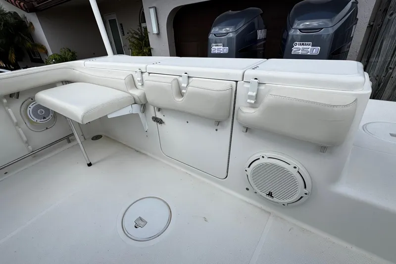 Slide: The Image of 2003 Triton 2895 CC boat interior with Yamaha 250 engines, white seating, and speaker. - 22
