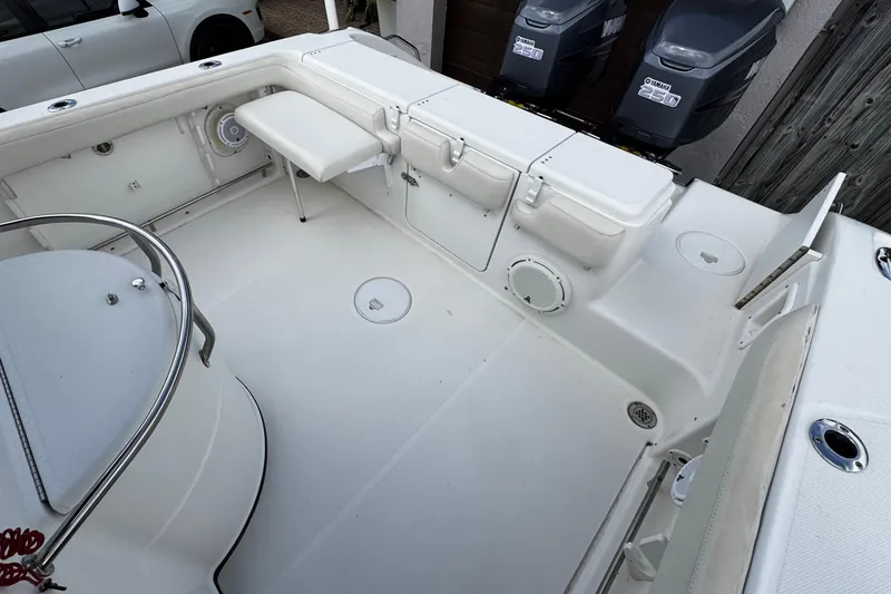 Slide: The Image of 2003 Triton 2895 CC boat interior with Yamaha 250 engines, spacious deck layout. - 23