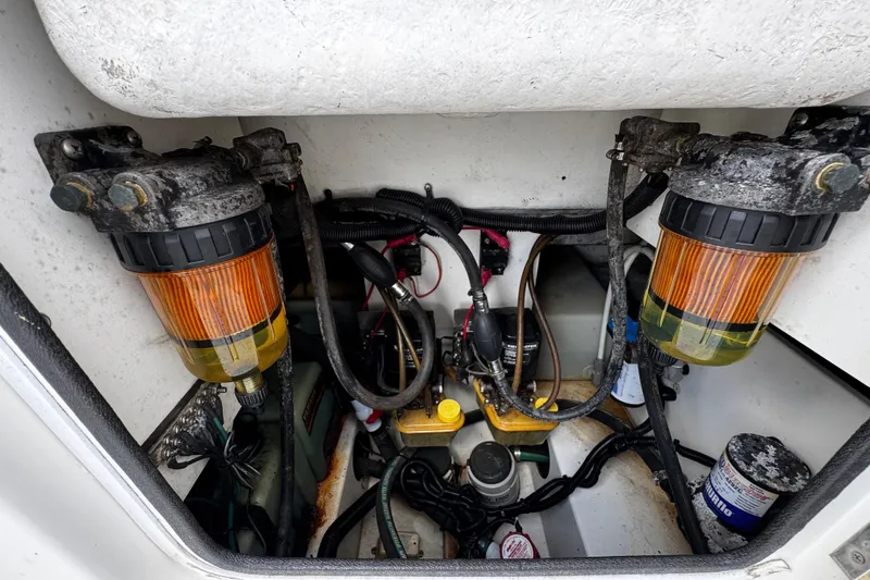 Slide: The Image of Engine compartment of a 2003 Triton 2895 CC boat, showing fuel filters and wiring. - 24
