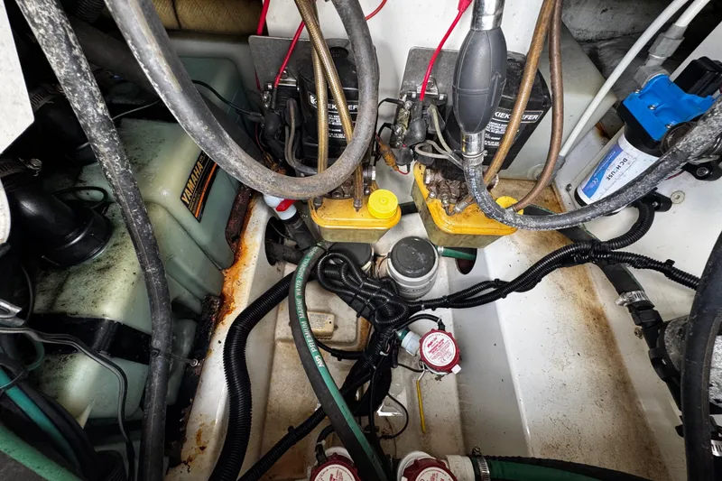 Slide: The Image of Engine compartment of a 2003 Triton 2895 CC boat, showing wiring and components. - 25