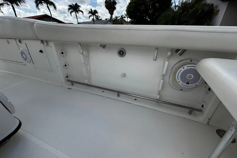 Slide: The Image of 2003 Triton 2895 CC boat interior with white seating and built-in speakers. - 28