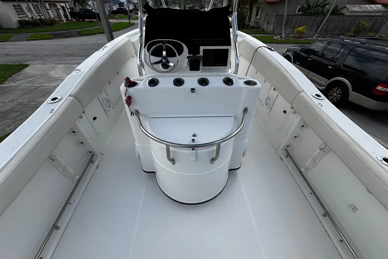 Slide: The Image of 2003 Triton 2895 CC boat interior with steering console and seating. - 29