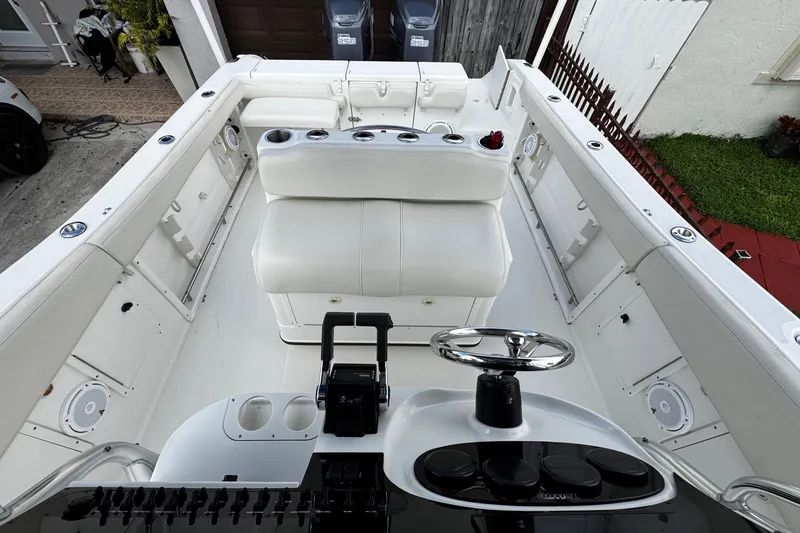 Slide: The Image of 2003 Triton 2895 CC boat interior with white seating and steering wheel. - 31