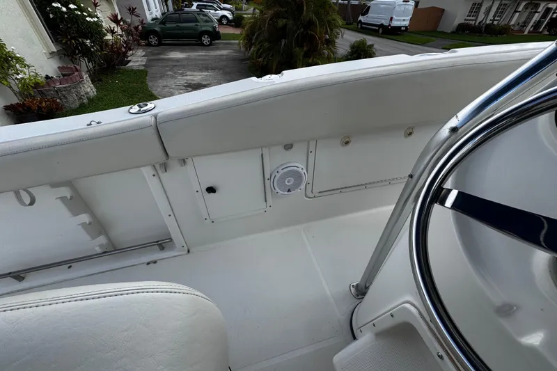 Slide: The Image of 2003 Triton 2895 CC boat interior with white seating and steering wheel. - 33