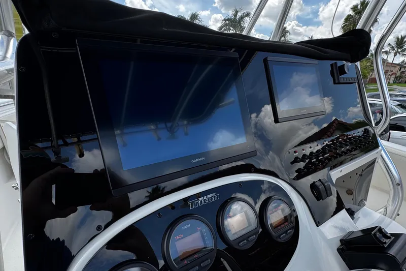 Slide: The Image of Dashboard of a 2003 Triton 2895 CC boat with Garmin displays and gauges. - 38