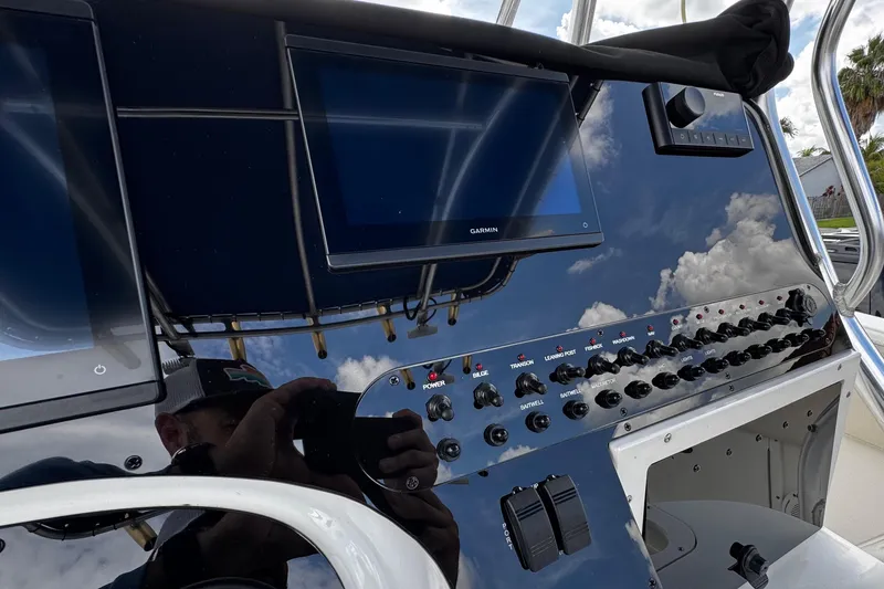 Slide: The Image of Control panel of a 2003 Triton 2895 CC boat with Garmin display and switches. - 41