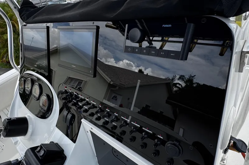 Slide: The Image of 2003 Triton 2895 CC boat dashboard with modern controls and displays. - 42