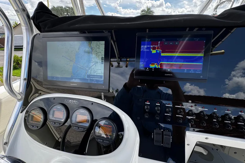 Slide: The Image of Dashboard of 2003 Triton 2895 CC boat with Garmin navigation displays. - 46