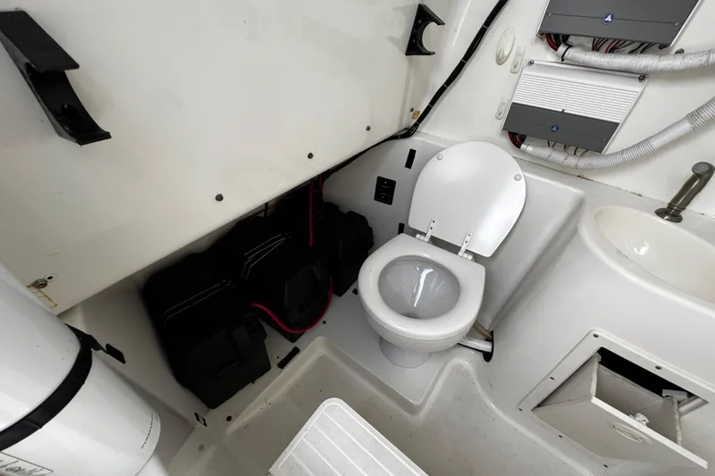 Slide: The Image of 2003 Triton 2895 CC boat interior with toilet and sink. - 50