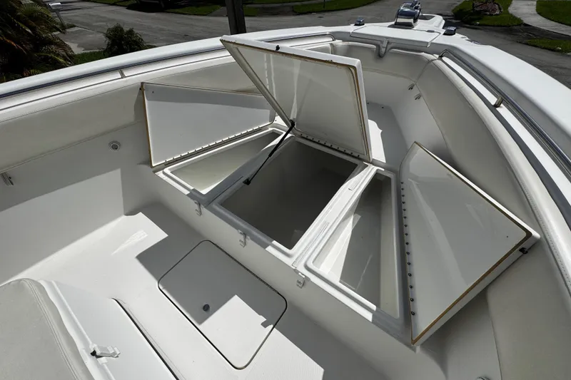 Slide: The Image of Open storage compartments on a 2003 Triton 2895 CC boat deck. - 53