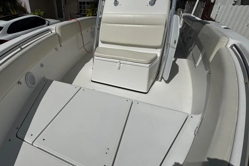 Slide: The Image of 2003 Triton 2895 CC boat interior with seating and storage compartments. - 58