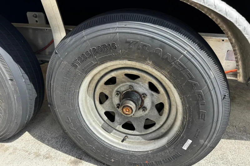 Slide: The Image of Trailer tire on a 2003 Triton 2895 CC, featuring TransEagle ST235/80R16 specifications. - 59