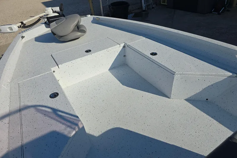 Slide: The Image of 2019 Xpress H24B boat deck with seating and storage compartments. - 10