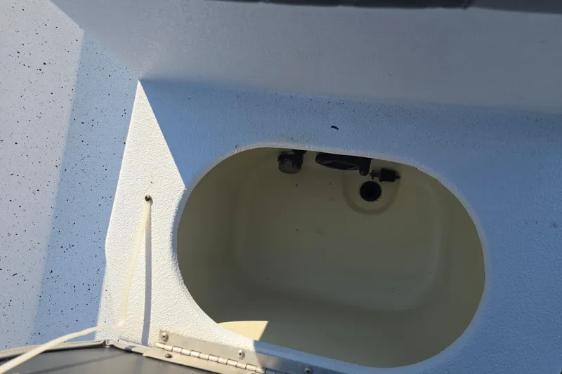 Slide: The Image of 2019 Xpress H24B boat compartment interior with white textured surface. - 11