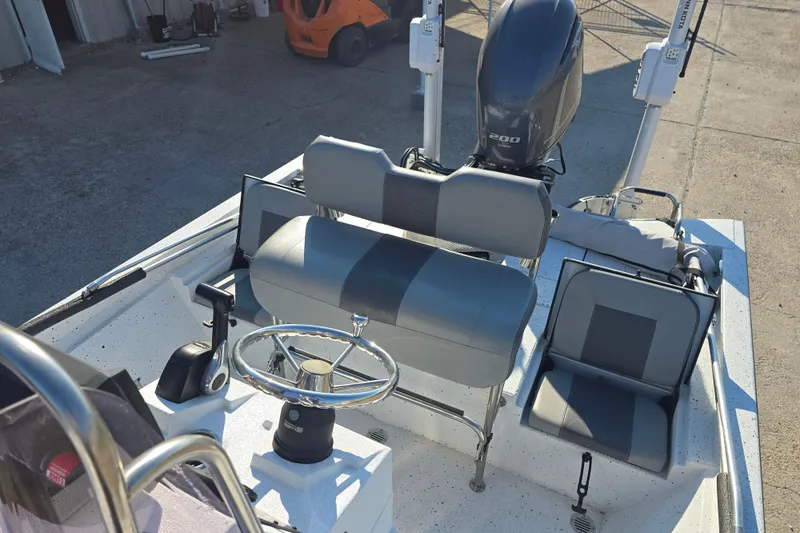 Slide: The Image of 2019 Xpress H24B boat interior with steering wheel and seating. - 14