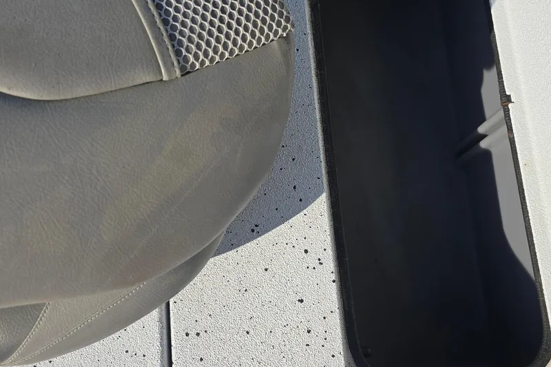 Slide: The Image of Gray seat and storage compartment on 2019 Xpress H24B boat. - 15