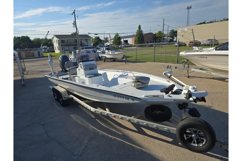 Slide: The Image of 2019 Xpress H24B boat on trailer in outdoor lot. - 2