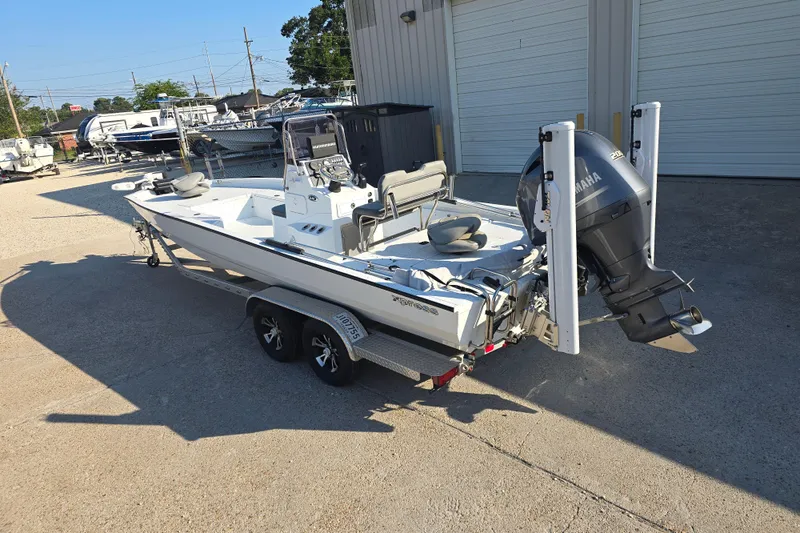 Slide: The Image of 2019 Xpress H24B boat with Yamaha engine on a trailer, parked outdoors. - 5