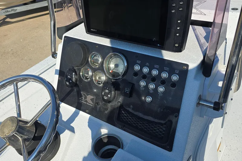 Slide: The Image of 2019 Xpress H24B boat dashboard with steering wheel and control panel. - 9
