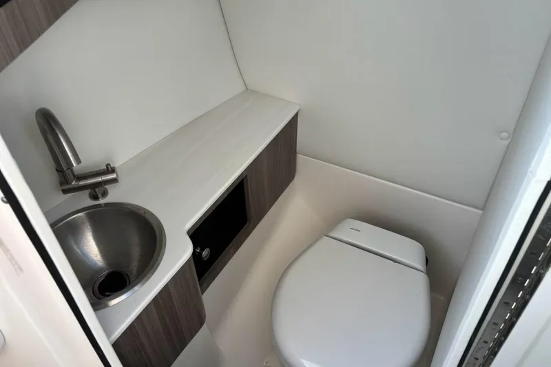 Slide: The Image of 2023 Regal LX6 boat bathroom with sink and toilet, modern design. - 10