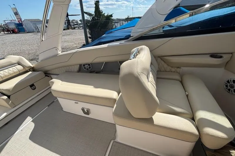 Slide: The Image of 2023 Regal LX6 boat interior with beige seating and modern design. - 12