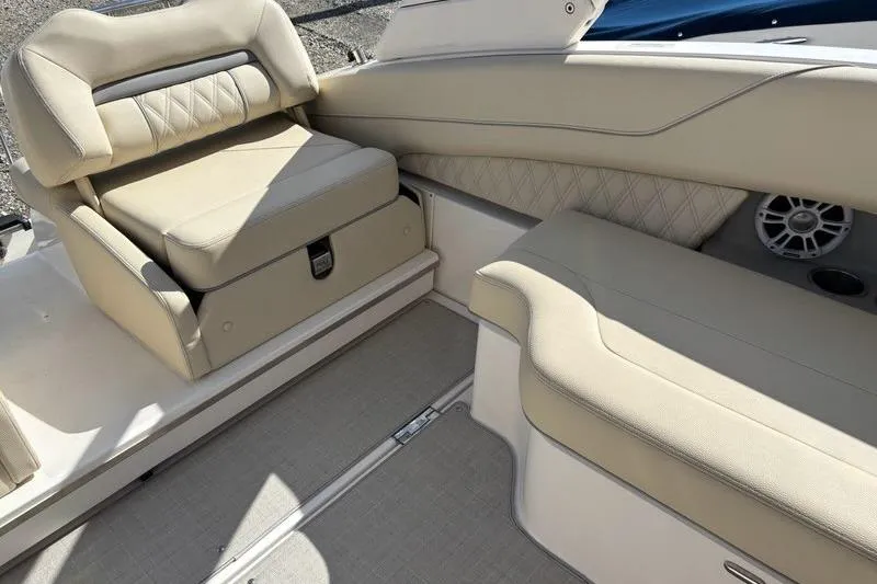 Slide: The Image of 2023 Regal LX6 boat interior with beige leather seating and speaker. - 14
