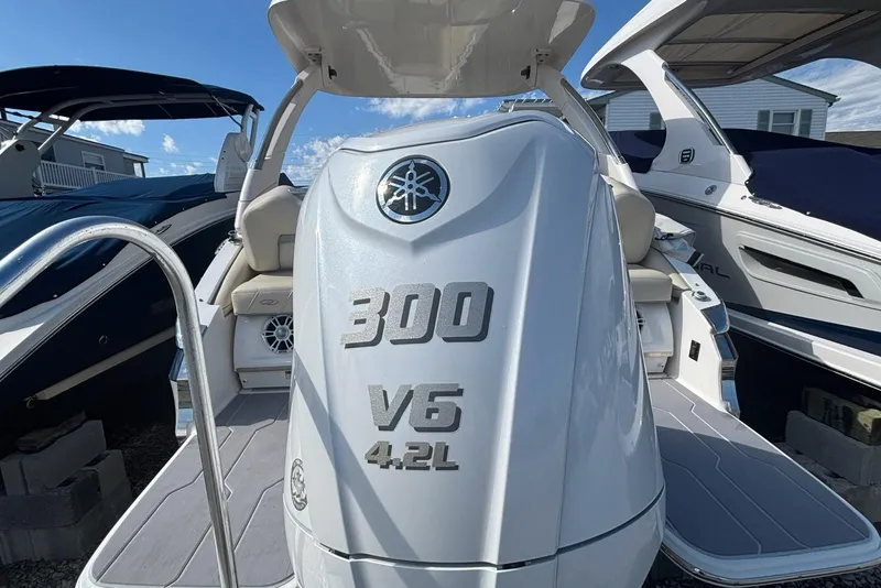 Slide: The Image of 2023 Regal LX6 boat with Yamaha 300 V6 4.2L engine, docked under clear skies. - 16