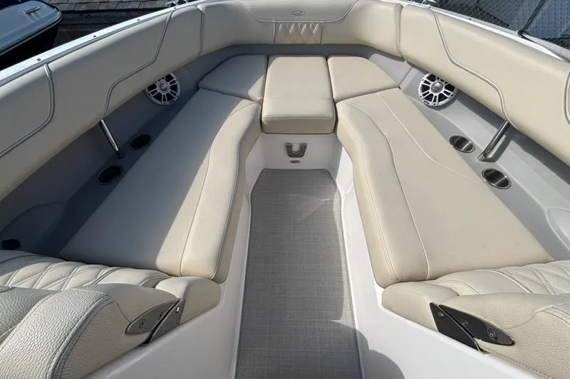 Slide: The Image of 2023 Regal LX6 boat interior with beige seating and modern design. - 2