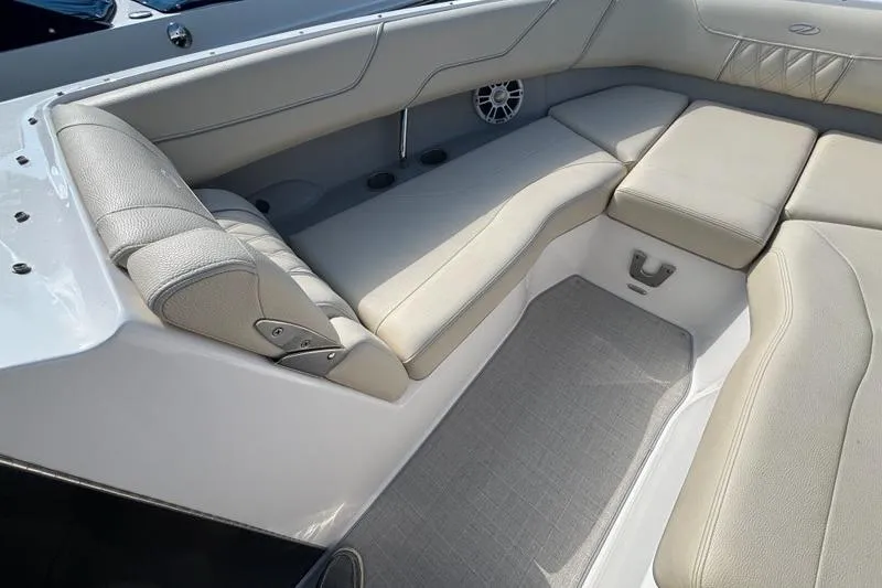 Slide: The Image of 2023 Regal LX6 boat interior with beige seating and speaker detail. - 3