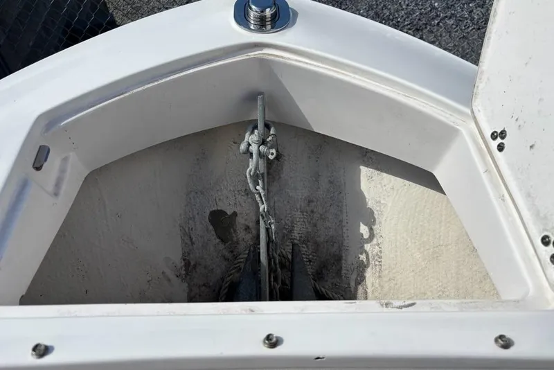 Slide: The Image of Anchor compartment of 2023 Regal LX6 boat, featuring chain and anchor storage. - 5