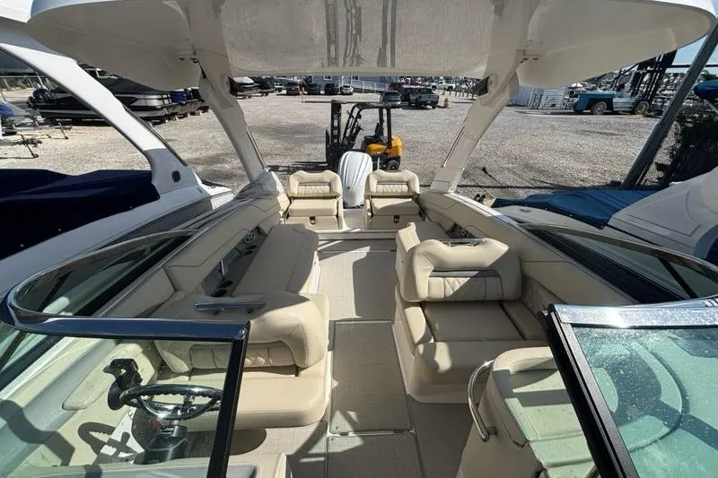 Slide: The Image of 2023 Regal LX6 boat interior with beige seating and modern design. - 6