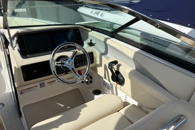 Slide: The Image of 2023 Regal LX6 boat interior with steering wheel and control panel. - 8
