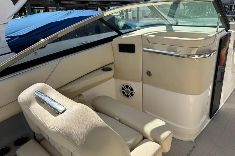 Slide: The Image of 2023 Regal LX6 boat interior with beige seating and modern dashboard design. - 9