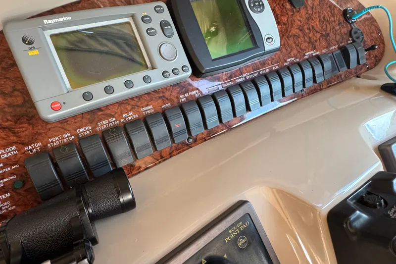 Slide: The Image of Control panel of a 2003 Sea Ray 380 Sundancer with navigation equipment and switches. - 15