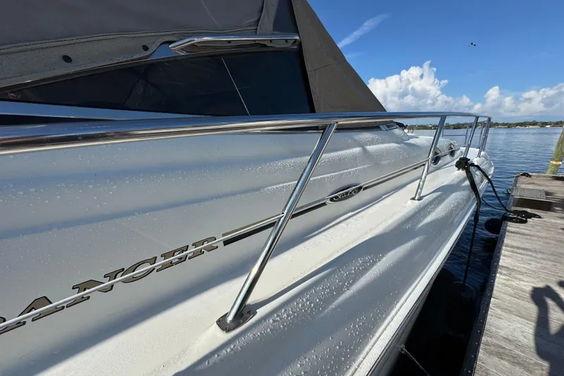 Slide: The Image of 2003 Sea Ray 380 Sundancer yacht docked, showcasing sleek design and chrome railings. - 4
