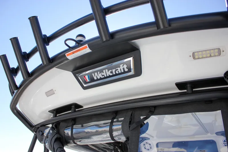 Slide: The Image of 2026 Wellcraft 38 T-Top boat with triple outboard engines on display. - 12