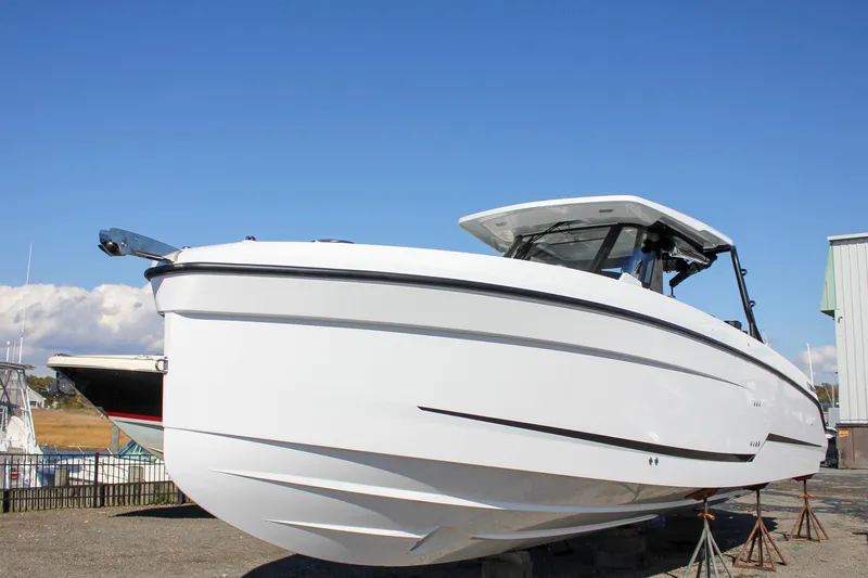 Slide: The Image of 2026 Wellcraft 38 T-Top boat on stands, clear sky background. - 13