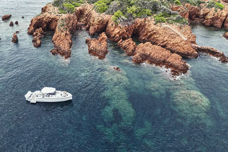 Slide: The Image of 2026 Wellcraft 38 T-Top boat, sleek design with modern windshield and seating. - 22