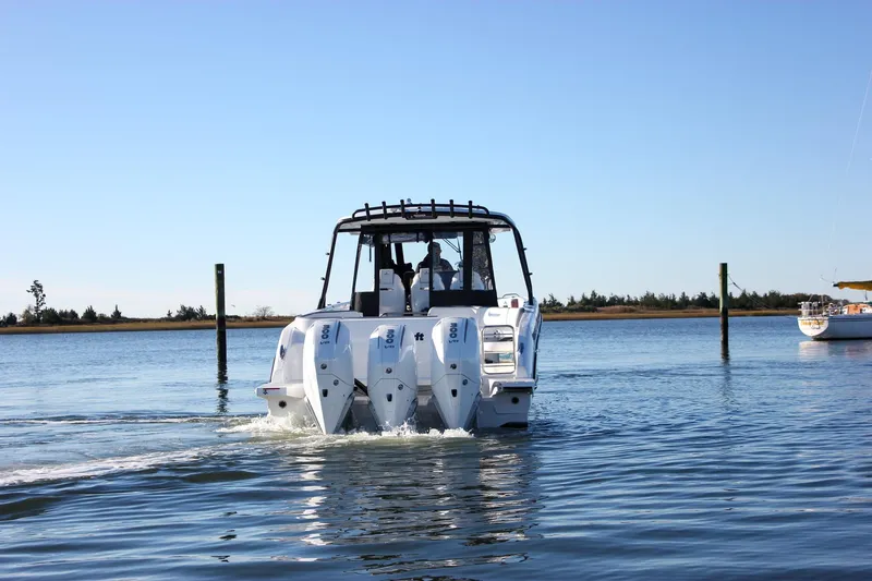 Slide: The Image of 2026 Wellcraft 38 T-Top boat docked at a marina on a sunny day. - 29