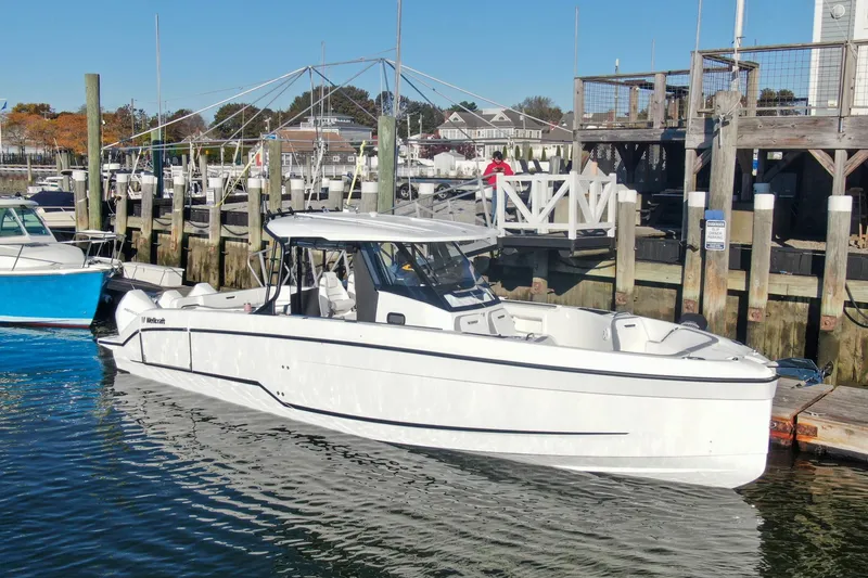 Slide: The Image of 2026 Wellcraft 38 T-Top boat interior with three luxury seats, overlooking calm waters. - 38