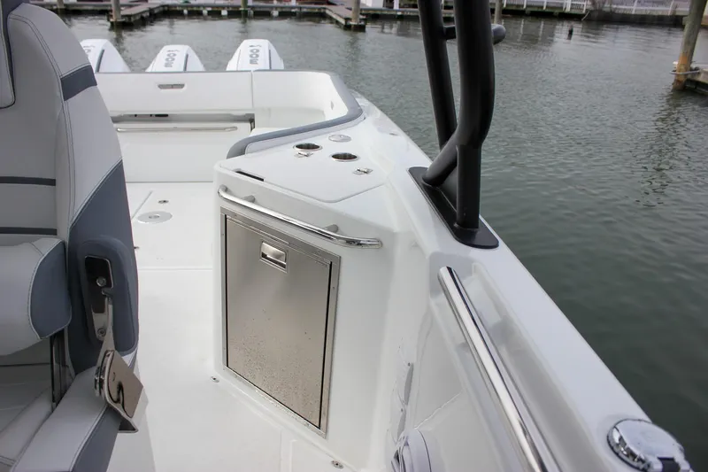 Slide: The Image of 2026 Wellcraft 38 T-Top boat interior with seating and storage, docked by the water. - 47