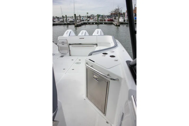 Slide: The Image of 2026 Wellcraft 38 T-Top boat interior with sleek design and modern amenities at a marina. - 48