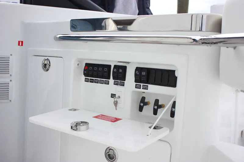 Slide: The Image of Control panel of 2026 Wellcraft 38 T-Top boat with switches and key. - 49