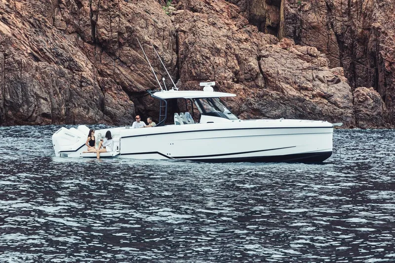 Slide: The Image of 2026 Wellcraft 38 T-Top boat docked with Mercury engines, sunny marina background. - 5