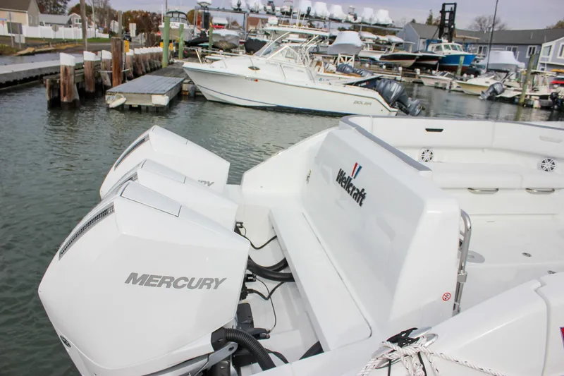 Slide: The Image of 2026 Wellcraft 38 T-Top boat with Mercury engines docked at a marina. - 52