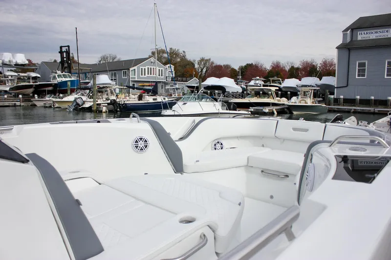 Slide: The Image of 2026 Wellcraft 38 T-Top boat docked at a marina with surrounding vessels. - 54