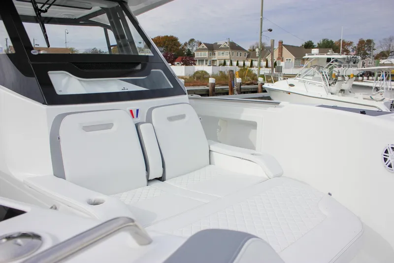 Slide: The Image of 2026 Wellcraft 38 T-Top boat interior with white seating and modern design. - 56
