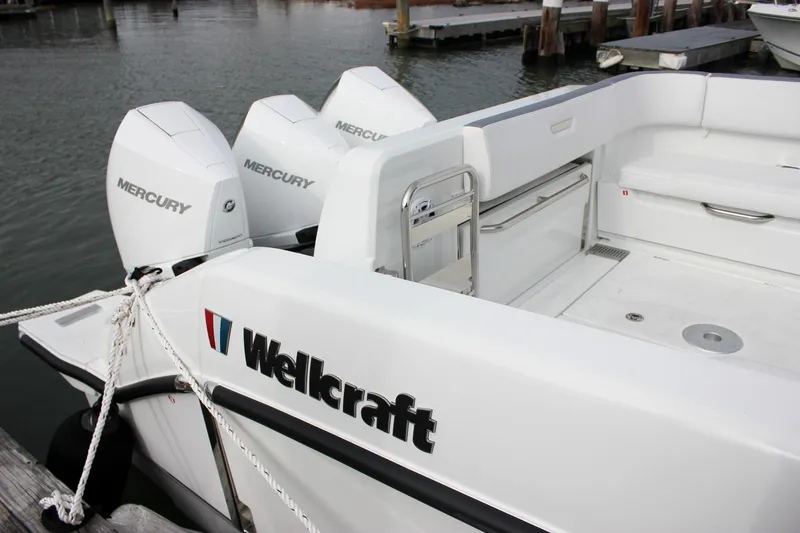 Slide: The Image of 2026 Wellcraft 38 T-Top boat with Mercury engines docked at marina. - 59