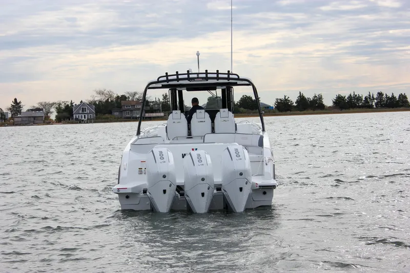 Slide: The Image of 2026 Wellcraft 38 T-Top boat with triple engines on a calm waterway. - 61